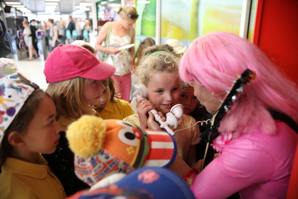 School Children visit Plymouth train station to see phone box, which plays a song they wrote. Plymouth train station, Plymouth, Devon, Britain.