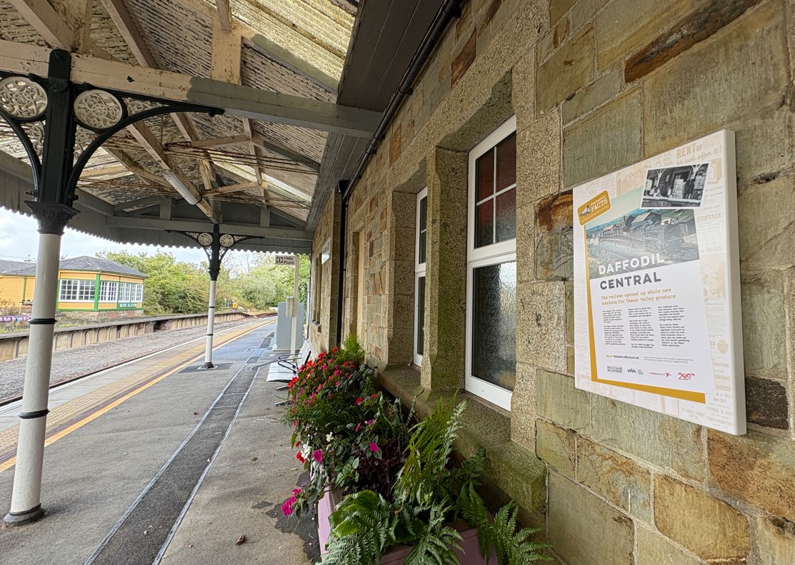 Interpretation board attached to wall at Bere Alston station