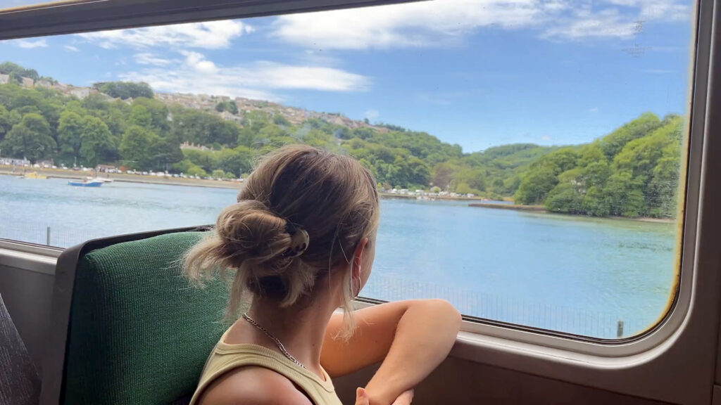 Passenger looking out train window on Looe Valley Line