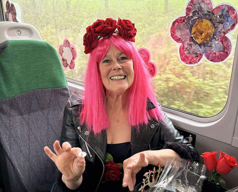Poet Sally Crabtree on train with craft materials and flowers